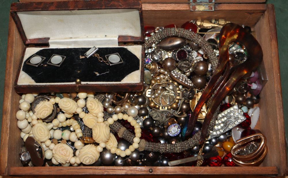 A small box of assorted costume jewellery.